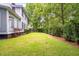 Lush backyard with green grass and mature trees, offering privacy and a peaceful outdoor space at 5152 Coral Reef Dr, Johns Island, SC 29455