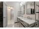 Bathroom featuring dual vanities, stylish mirrors, and a doorway to another room at 5152 Coral Reef Dr, Johns Island, SC 29455
