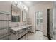 Bathroom with dual vanities, marble countertops, and unique tile flooring at 5152 Coral Reef Dr, Johns Island, SC 29455