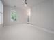 Bright bedroom with whitewashed floors and doors to outside at 5152 Coral Reef Dr, Johns Island, SC 29455