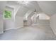 Bright bonus room featuring a charming chandelier, vaulted ceilings, and carpeted floors at 5152 Coral Reef Dr, Johns Island, SC 29455
