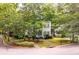 A charming two-story home featuring a cozy front porch and beautifully landscaped surroundings with mature trees at 5152 Coral Reef Dr, Johns Island, SC 29455