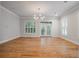 Bright living room with hardwood floors, plantation shutters, and a modern chandelier at 5152 Coral Reef Dr, Johns Island, SC 29455