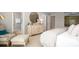 Relaxing bedroom featuring soft colors, a decorative cabinet, and a doorway to the en suite bathroom at 547 Verdi Drive Dr, Summerville, SC 29486
