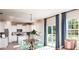 Living room area with a view to the modern white kitchen and access to the patio at 547 Verdi Drive Dr, Summerville, SC 29486