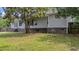 A well-maintained backyard with green grass and mature trees, adding privacy to this lovely home at 600 Dolphin Dr, Summerville, SC 29485
