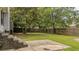Lush backyard with patio, retaining wall, offering a serene outdoor space for relaxation at 600 Dolphin Dr, Summerville, SC 29485