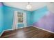 A colorful bedroom with hard wood floors, large windows, a ceiling light and two-tone walls at 600 Dolphin Dr, Summerville, SC 29485