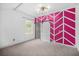 Bedroom with eye-catching pink accent wall, barn door, neutral carpet, and natural light at 600 Dolphin Dr, Summerville, SC 29485