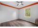 Spacious bedroom with hardwood floors, ceiling fan, and a window with outdoor views at 600 Dolphin Dr, Summerville, SC 29485