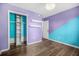 Bedroom with blue and purple walls, hardwood floors and closet with shelving at 600 Dolphin Dr, Summerville, SC 29485