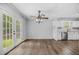 Open dining area with French doors, ceiling fan, and view to kitchen area at 600 Dolphin Dr, Summerville, SC 29485