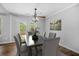 Open dining area with French doors, ceiling fan, and seating for six at 600 Dolphin Dr, Summerville, SC 29485