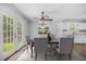 Open dining area with French doors, ceiling fan, and seating for six at 600 Dolphin Dr, Summerville, SC 29485