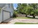 Paved driveway leading to garage with green grass and wooden fence on the side at 600 Dolphin Dr, Summerville, SC 29485