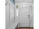 Bright entryway with a coat rack, bench, and white painted door at 600 Dolphin Dr, Summerville, SC 29485