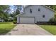 Attached two-car garage featuring security camera and visible utilities, set against a grassy lawn at 600 Dolphin Dr, Summerville, SC 29485