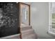 Hallway with carpeted steps leading to another room with a chalkboard wall and window at 600 Dolphin Dr, Summerville, SC 29485