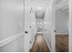 Hallway with base-molding detail, door to bathroom, and wood-look laminate flooring at 600 Dolphin Dr, Summerville, SC 29485