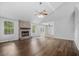Spacious living room featuring hardwood floors, vaulted ceiling, and brick fireplace at 600 Dolphin Dr, Summerville, SC 29485