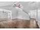 Open living space with vaulted ceilings, hardwood flooring, staircase and entry door at 600 Dolphin Dr, Summerville, SC 29485