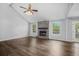 Open-concept living room with hardwood floors, vaulted ceiling, and a brick fireplace at 600 Dolphin Dr, Summerville, SC 29485