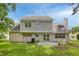 View of home's backyard featuring green lawn, neutral siding, windows, and patio area at 633 Alwyn Blvd, Summerville, SC 29485