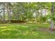 Large, well maintained backyard, surrounded by mature trees and a wood fence at 633 Alwyn Blvd, Summerville, SC 29485