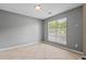 Bright, empty bedroom featuring neutral walls, tile floors, and a window at 633 Alwyn Blvd, Summerville, SC 29485