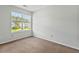 Spacious, sunny bedroom with neutral decor, carpet floor and a large window with blinds at 633 Alwyn Blvd, Summerville, SC 29485