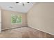Bright bedroom featuring carpet floors, a ceiling fan, and a window with views of mature trees at 633 Alwyn Blvd, Summerville, SC 29485