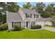 Traditional home featuring lush green lawn, mature trees, and tidy landscaping at 633 Alwyn Blvd, Summerville, SC 29485