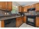Well-lit kitchen featuring wood cabinetry, black appliances, and a window view at 633 Alwyn Blvd, Summerville, SC 29485