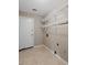 Tiled laundry room featuring a white door, shelving, and utility hookups at 633 Alwyn Blvd, Summerville, SC 29485