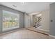Well-lit living room showcasing tile flooring, a front door, and a staircase at 633 Alwyn Blvd, Summerville, SC 29485