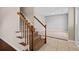 Carpeted staircase with wood railing leading to a tiled entryway and living space at 633 Alwyn Blvd, Summerville, SC 29485