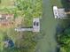 Aerial view of waterfront property with private dock, chairs, boat and garden beds at 689 Port Cir, Charleston, SC 29412