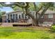 Backyard with a spacious deck, outdoor seating, a swing, and mature landscaping at 689 Port Cir, Charleston, SC 29412