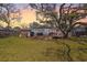 Large backyard with beautiful trees and a deck featuring outdoor dining and seating area at 689 Port Cir, Charleston, SC 29412