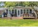 Backyard with a spacious deck, outdoor seating, grill, and mature landscaping at 689 Port Cir, Charleston, SC 29412