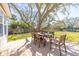 Spacious deck with a dining table, chairs, and shade from a mature tree at 689 Port Cir, Charleston, SC 29412