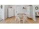 Light-filled dining room featuring hardwood floors, white cabinets, and a wooden table with seating at 689 Port Cir, Charleston, SC 29412