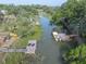 This aerial view shows a dock and a boat along a grassy canal at 689 Port Cir, Charleston, SC 29412