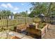 Outdoor garden featuring raised garden beds, gravel, and stone pathways nestled in a fenced backyard at 689 Port Cir, Charleston, SC 29412
