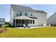 Expansive backyard featuring screened patio, a large lawn, and patio seating at 7011 Pumpkinseed Dr, Johns Island, SC 29455