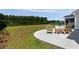 Beautiful backyard with lake view, lush grass, a concrete patio, and patio furniture at 7011 Pumpkinseed Dr, Johns Island, SC 29455