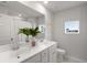 Bright bathroom with double vanity, white cabinets, and a decorative plant for added freshness at 7011 Pumpkinseed Dr, Johns Island, SC 29455