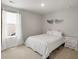 Cozy bedroom featuring neutral carpet, a queen bed, and decorative angel wings at 7011 Pumpkinseed Dr, Johns Island, SC 29455