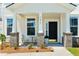 Inviting front porch featuring brick supports, a seating area, and views of the home's facade at 7011 Pumpkinseed Dr, Johns Island, SC 29455
