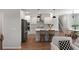 Open kitchen boasts stainless steel appliances, island with bar stool seating, and a modern design at 7011 Pumpkinseed Dr, Johns Island, SC 29455
